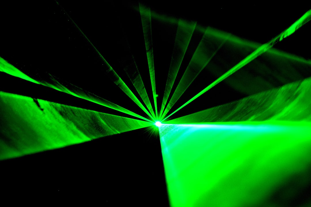 a green light is shining in the dark